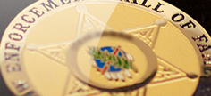 Closeup of the Oklahoma Law Enforcement Hall of Fame seal with the Osage shield inside a six-pointed star