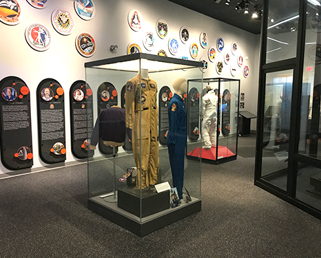 Exhibit panels and flight suits on display
