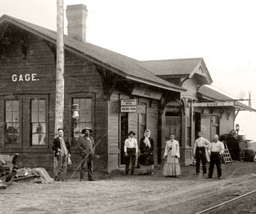 Historic 1906 photograph of men and women standing in front of the railroad depot in Gage, Oklahoma 