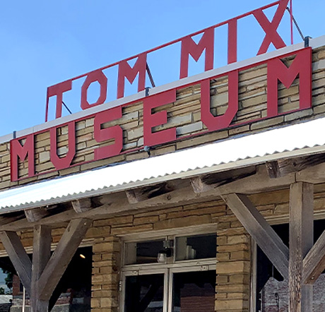 A large sign reading "Tom Mix Museum" rises above the museum entrance.