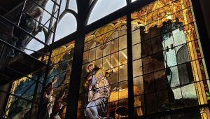 Detail of Jesus, Mary, and Joseph in a stained-glass window.