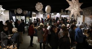 Guests mingle at the Museum of the Western Prairie holiday market.