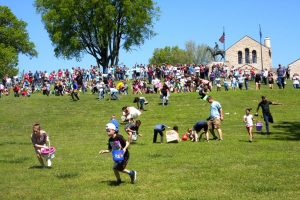 Children scramble to collect Easter eggs at Will Rogers Memorial Museum.