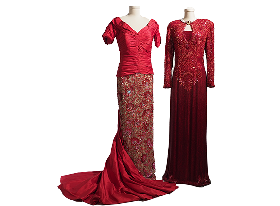 Two red ballgowns, one with short sleeves and a satin bodice and train, and a beaded skirt; the other a long-sleeved gown with ornate beading at the top