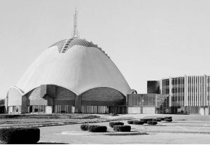 First Christian Church in Oklahoma City. A domed, egg structure rises above the building. Archways below lead into the main sanctuary. This image was used for the Preservation Plan cover by the State Historic Preservation office.