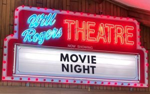 The lit neon marquee above the Will Rogers Theatre