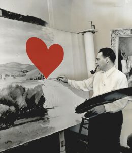 Richard Goetz painting a mural. A large heart has been placed on the canvas as a graphic.