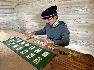 Seth Goff demonstrates an 1860s card game at the Fort Gibson stockade.
