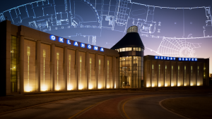 A photo of the Oklahoma History Center at twilight with the blueprints of the building superimposed on the sky