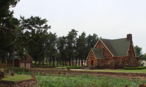 20th century Tudor Revival-style home, built in 1942. The Rock House and yard are built and adorned with fieldstone.