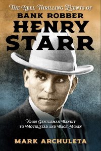 A book cover of the title "The Reel Thrilling Events of Bank Robber Henry Starr" featuring a central image of Henry Starr in a fedora, and the book title and subtitle overlayed on the image.