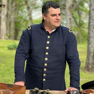 A man dressed in a Union uniform makes a presentation