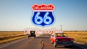 Two cars travel on Route 66 and the words "First 100 Years"