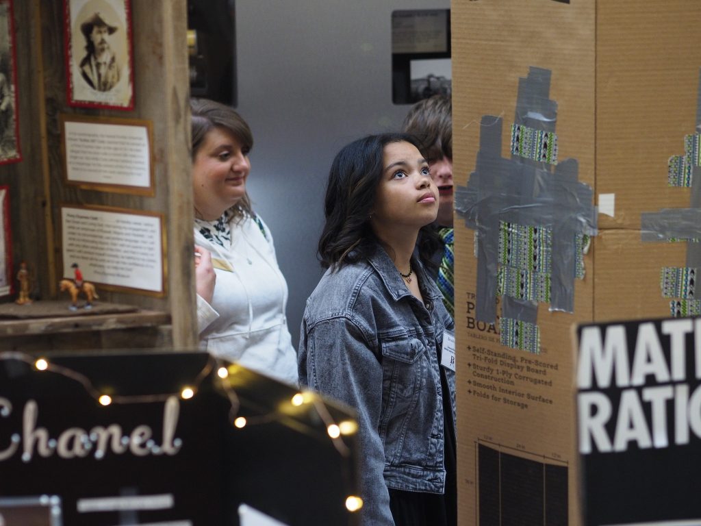 Students reading OkNHD presentations