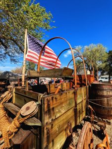 A chuck wagon flies an American flag.