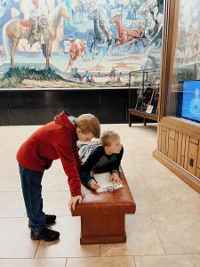 Children work together on a scavenger hunt at the Will Rogers Memorial Museum.