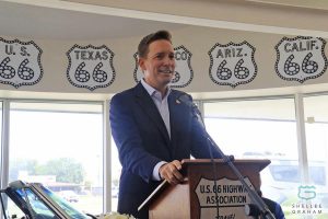 Matt Pinnell stands at a podium at the Oklahoma Route 66 museum.