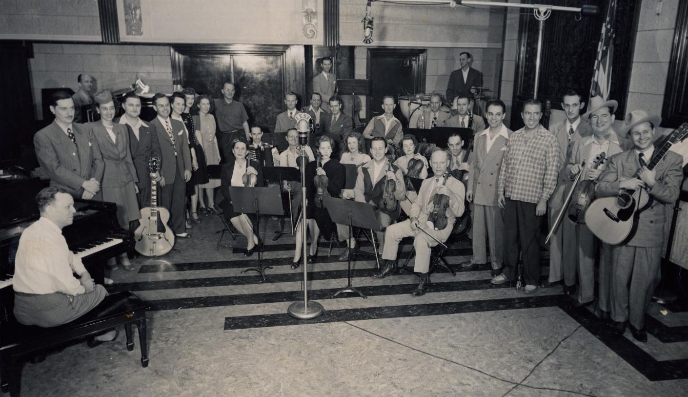 Kilgen Radio show performers stand in the recording studio of the Skirvin.