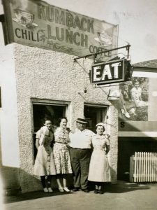 Three women and a man stand at the Kumback Lunch diner.