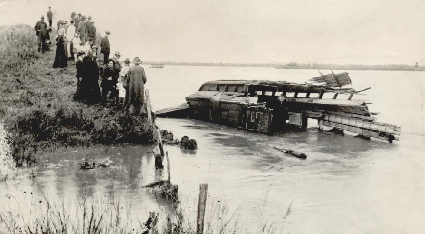A passenger car submerged in the Cimarron River after a train accident in Dover, 1906.