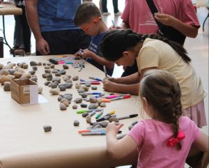 Youngsters gather at an activity table with colored markers