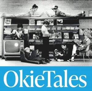 Children on bookshelves and in chairs and standing reading books.