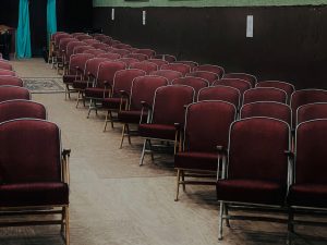 Red theater chairs lined in rows
