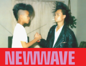 Two teenagers shake hands, both with tall mohawk hairstyles.