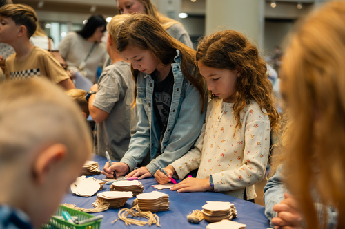 Children gather around a craft table during homeschool day at the Oklahoma History Center.