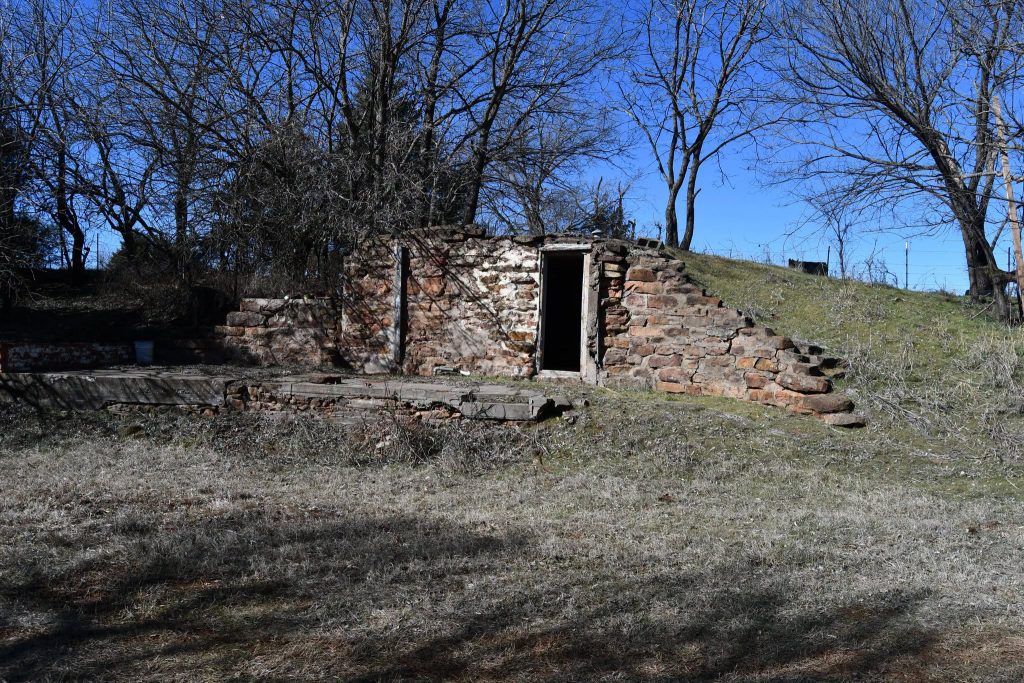 A dugout created from red sandstone and a central doorway.