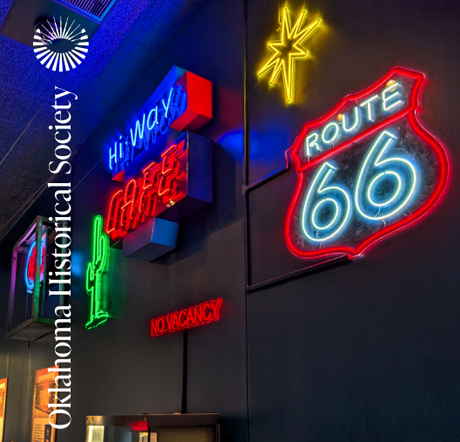 The annual report cover features small neon Route 66 signs on exhibit.