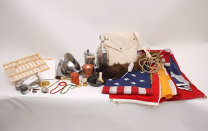 Flags, a metal helmet, canvas bag, and other items from the Fur Trade trunk