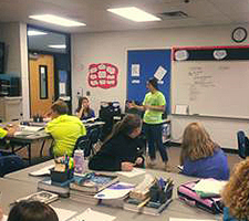 An educator speaks to a classroom of students.