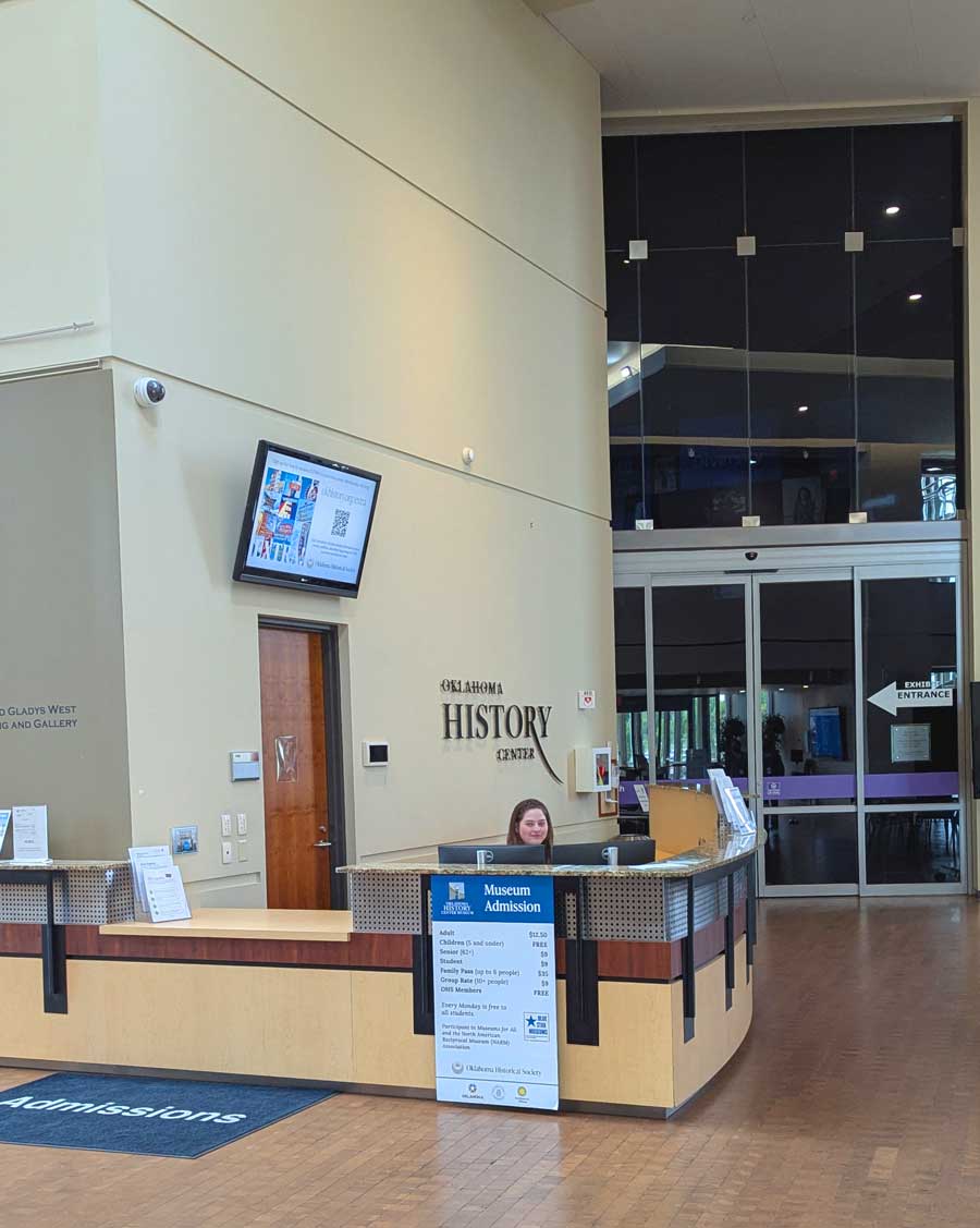 A staff member sitting behind the admissions desk