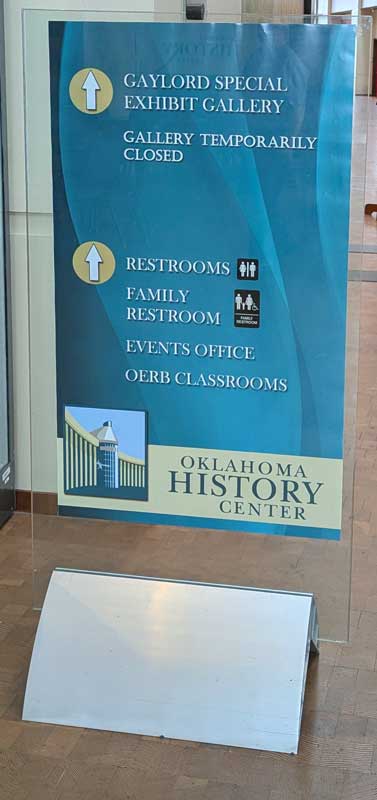 A sign pointing the way to exhibits, restrooms, and other spaces