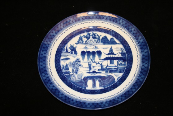 A plate with blue Asian-style landscape designs