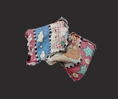 Two bean bags covered in colorful fabric.