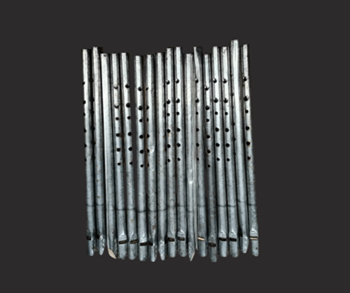 A row of rustic tin whistles.