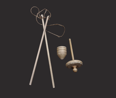 Two skinny wooden sticks connected with string next to a small wooden toy top.