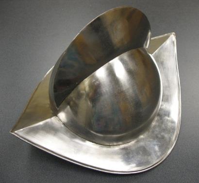 A high-crested metal helmet with a curved brim.