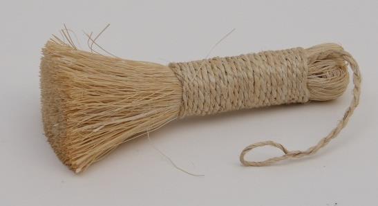 A brush with long stiff bristles, with woven cord and a loop around the handle.