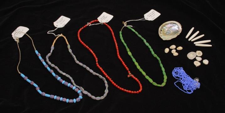 Strands of beads in various colors and sizes, shells, and long tubular hairpipe beads.