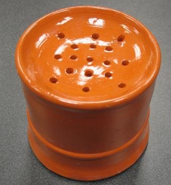 A small cylindrical container with holes in the top.