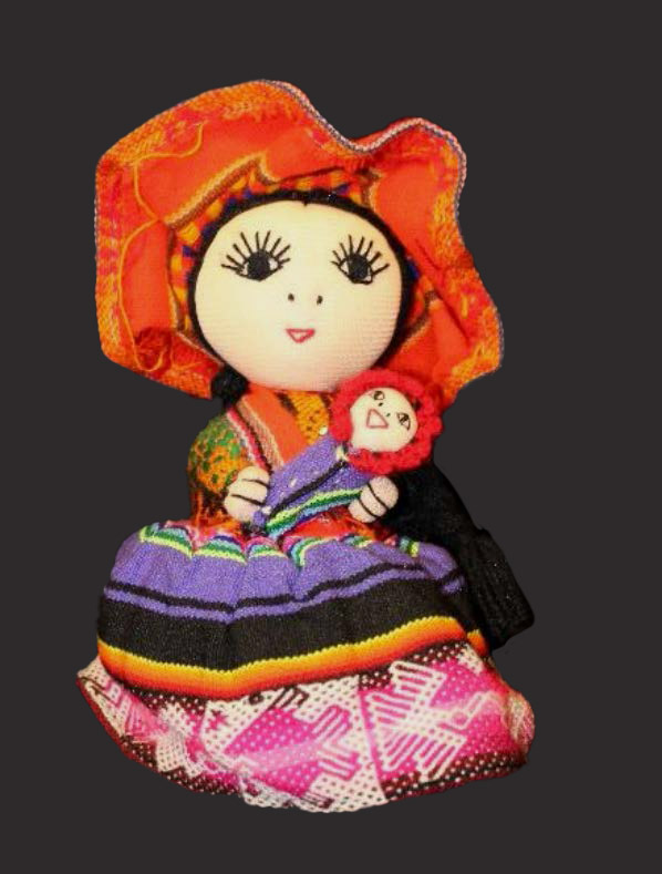 A doll in a brightly-colored hat and dress holding a smaller baby doll.