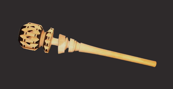 A wooden implement with a long handle and notches on the ball-shaped end.