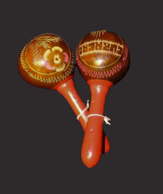 Two wooden maracas decorated with flower, palm, and zig-zag patterns.