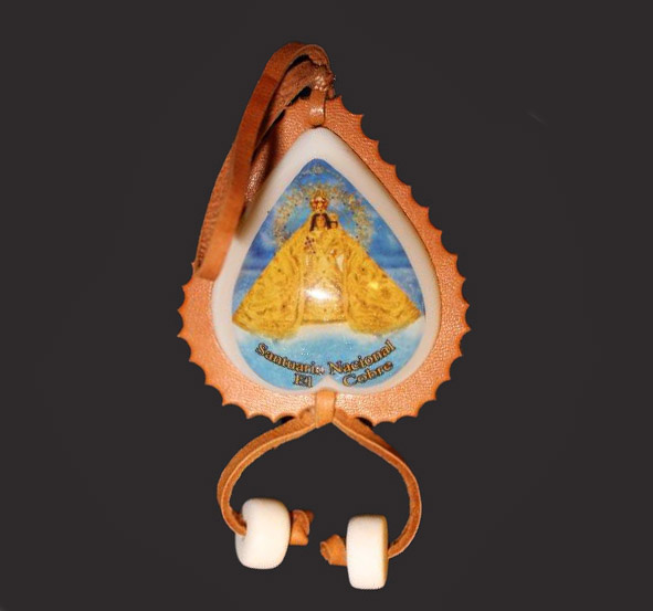 A leather keychain with a figure in a crown and flowing gold robes. Two beads hang from the bottom.
