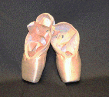 Shiny pink ballet shoes with a flat toe box and long ribbons.