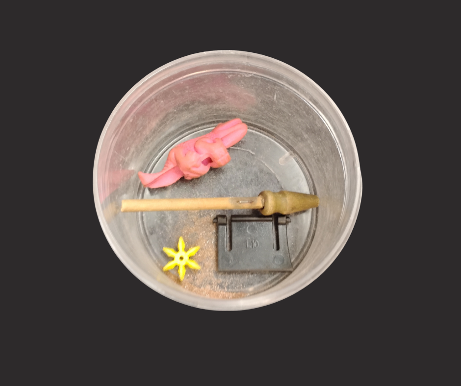 A metal bucket containing small items