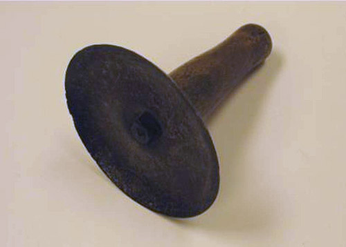 The scraper resembles the shape of a funnel. It is held by the tapered end and the wide end is used to scrape.